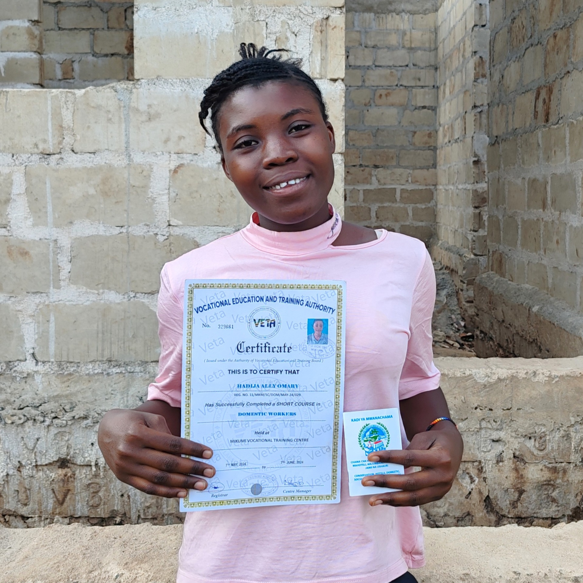 Hadija, a Domestic worker from Tanzania with her professional certificate and union membership card.She completed the Professional Training course in Mikumi VETA centre in May 2024 and is secretary of her DW Association in Morogoro