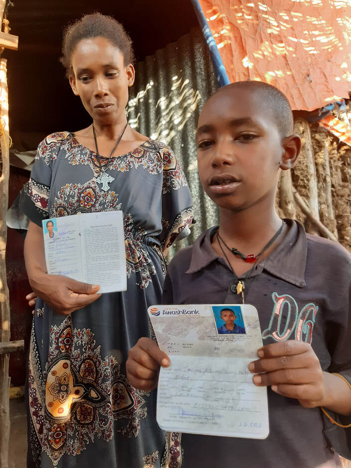 Nitsuh Aychew and her eldest son Thomas Actimasus with their savings accounts